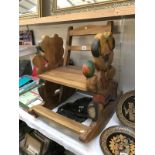 A childs rocking chair with carved teddy bear sides