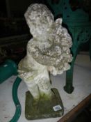 A stone garden ornament of a child with flowers
