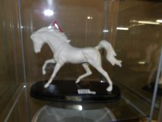 A Beswick white horse on base.