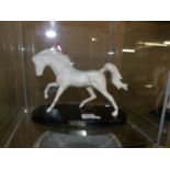 A Beswick white horse on base.