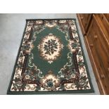 A medium sized rug with green background (approximately 45.