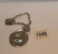 A silver pendant and chain, approximately 56 grams.