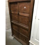 A vintage industrial pine cupboard with sliding doors