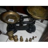 A set of scales with brass weights.