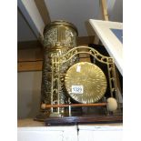 A brass dinner gong and a brass stick stand.