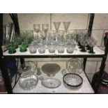 Two shelves of glasses, bowls, etc.