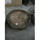 A stone bird bath (no base)