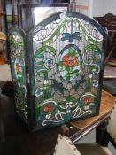 A Tiffany style glass fire screen