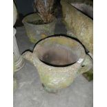 A pair of stone planters in the form of decorative watering cans