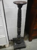 A Victorian black lacquered turned & carved wooden torchiere stand