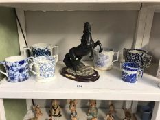 6 assorted blue and white loving cups a/f and a figure of a rearing horse