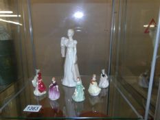 A figure of a lady and 6 miniature figures.