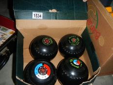 A set of 4 lawn bowls.