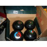 A set of 4 lawn bowls.