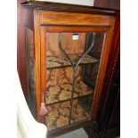An Edwardian mahogany inlaid astragal glazed display cabinet.