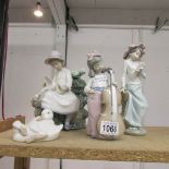 4 NAO figurines being lady sitting with doves, lady with dove, girl with cello and geese.