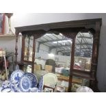 A large over mantle mirror in dark wood frame