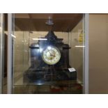 A black slate mantel clock with key.