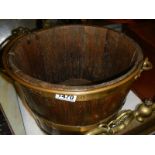 A brass bound wooden bucket.