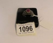 A custom made white gold ring set large ruby and diamonds, size Q.