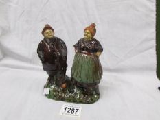 A glazed/treacle ware of a man and woman entitled 'Zebrugge-mole'.