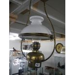 A brass hanging oil lamp.