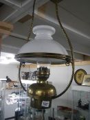 A brass hanging oil lamp.