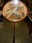 A Victorian mahogany pole screen with tapestry panel.
