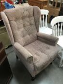 A pink fabric covered Parker Knoll style chair