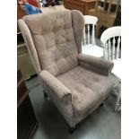 A pink fabric covered Parker Knoll style chair