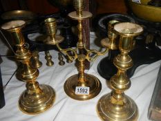 A brass candelabra and a pair of brass candlesticks.