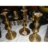 A brass candelabra and a pair of brass candlesticks.