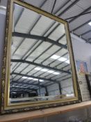 A large gilt framed bevel edged mirror. Approx.