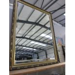 A large gilt framed bevel edged mirror. Approx.