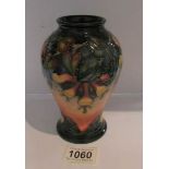 A Moorcroft vase with floral pattern, approximately 6.25" tall.