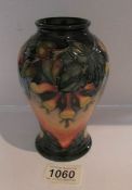 A Moorcroft vase with floral pattern, approximately 6.25" tall.