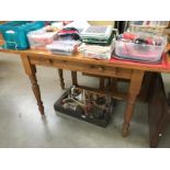 A pine kitchen table with 1 drawer