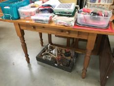 A pine kitchen table with 1 drawer