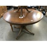 S dark wood stained round dining table on brass lions paws castors