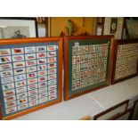 3 framed and glazed sets of cigarette cards depicting flags of the world.