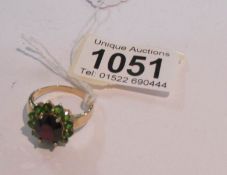 A garnet and tourmaline cluster ring in gold, size T half.