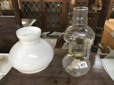 An oil lamp and a shade