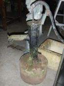 vintage water pump on stone base & other pump