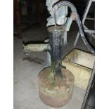 vintage water pump on stone base & other pump