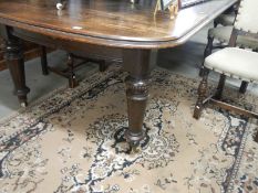 A large oak dining table with winding handle