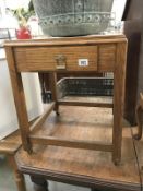 A tile topped oak side table with drawer