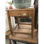 A tile topped oak side table with drawer