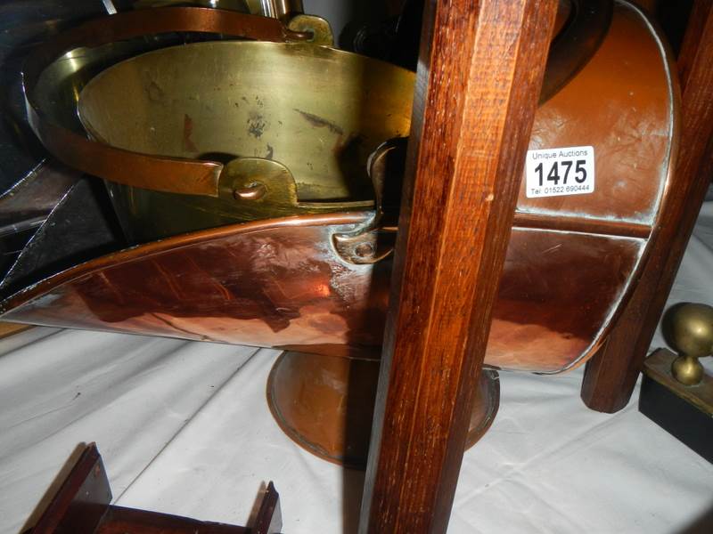 A copper coal scuttle and a brass jam pan.
