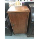 A 1950's oak ply cupboard