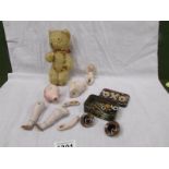 A small vintage teddy bear, a porcelain doll (a/f), a miniature porcelain doll, glass eyes etc.